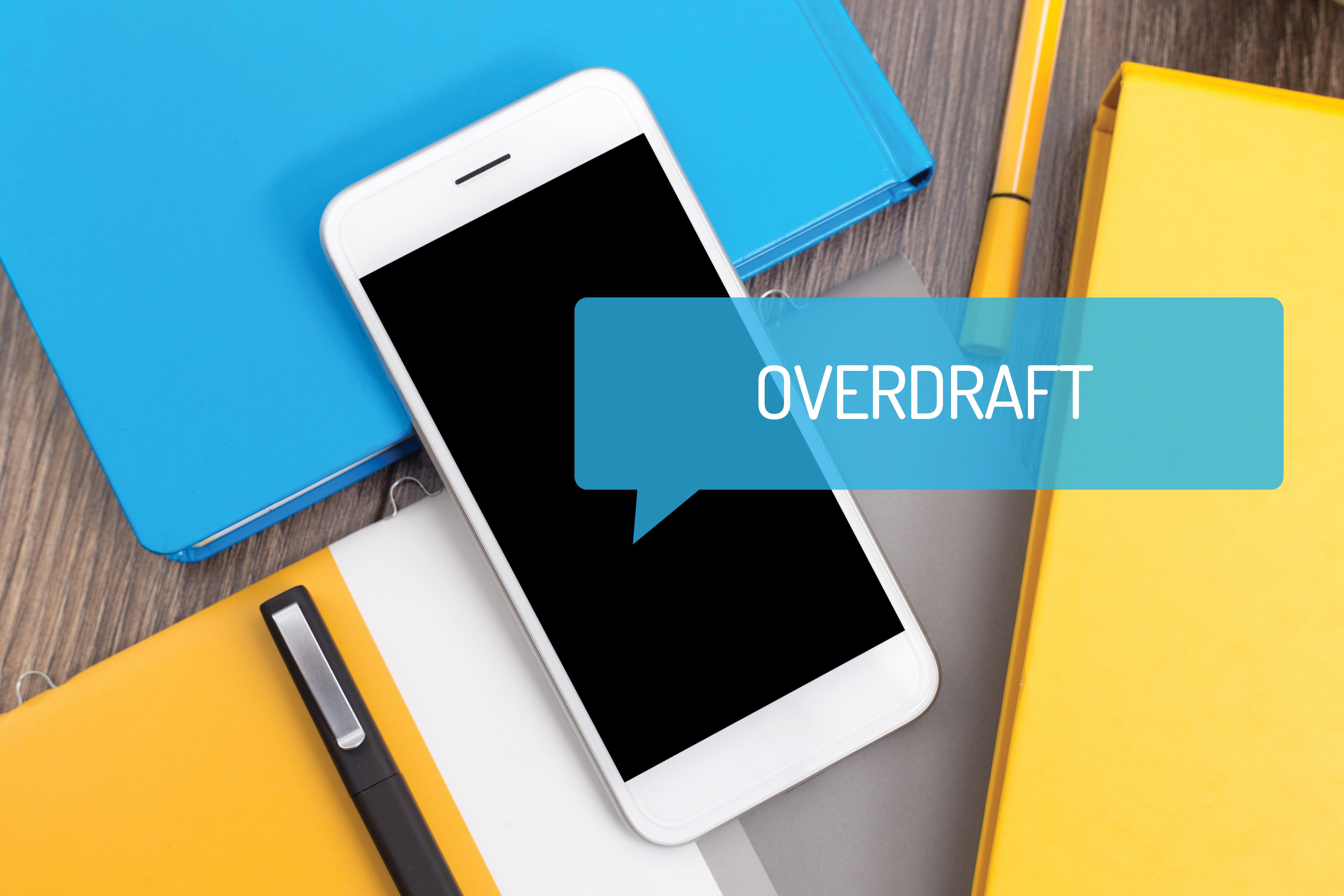 Photo of smartphone with overdraft notice flashing